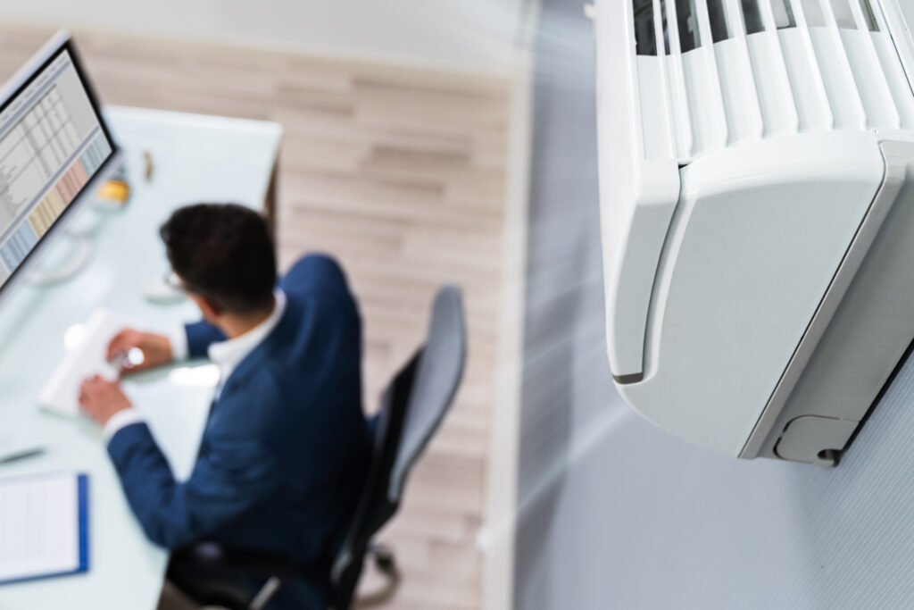 Businessman Enjoying The Cooling Of Air Conditioner